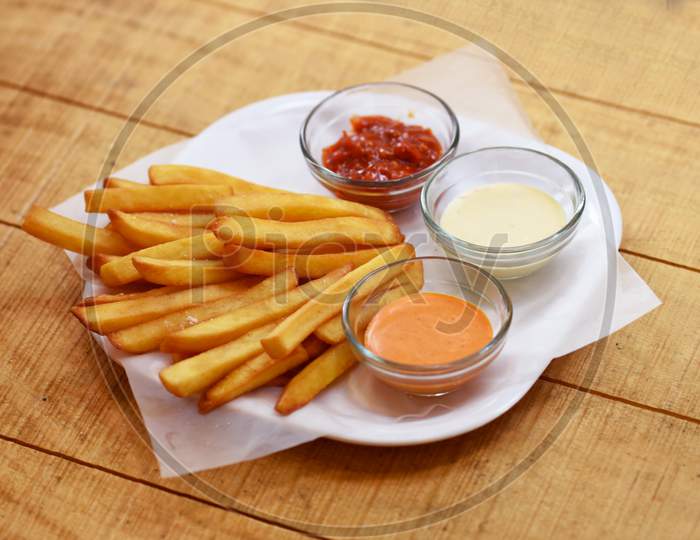 Tasty French Fries On Wooden Table Background