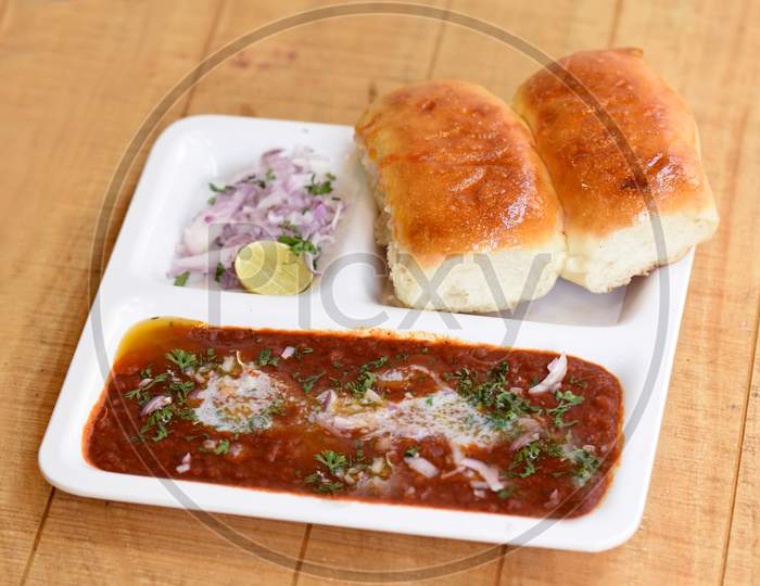Indian Delicious Pav Bhaji With Onion And Coriander Spread On Top Of Curry Wheat Bread Pav Bhaji Fast Food Dish From India.