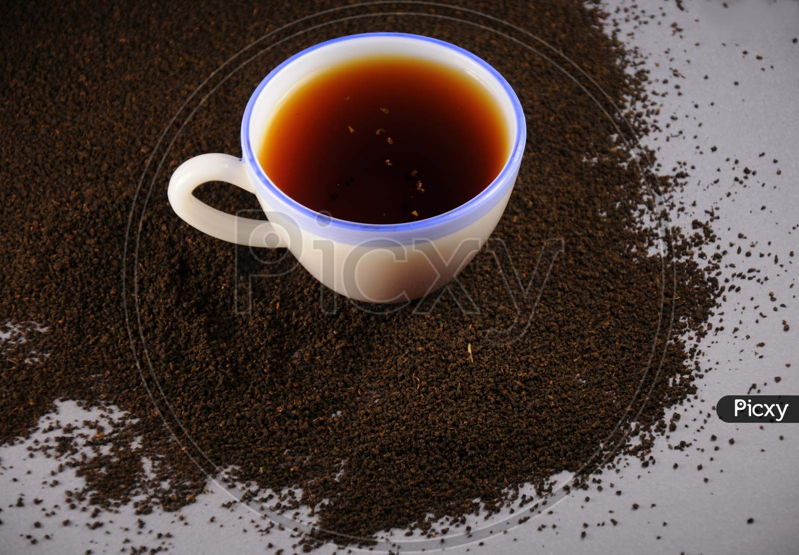 Cup Of Tea With And Black Tea Leaves