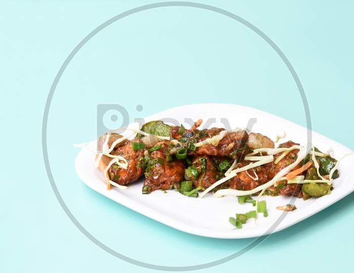 Chilli Paneer Or Spicy Cottage Cheese, Garnish With Capsicum, Onion,Cabbage And Spring Onion, Favourite Indian Starter Menu, Served In White Dish,Selective Focus