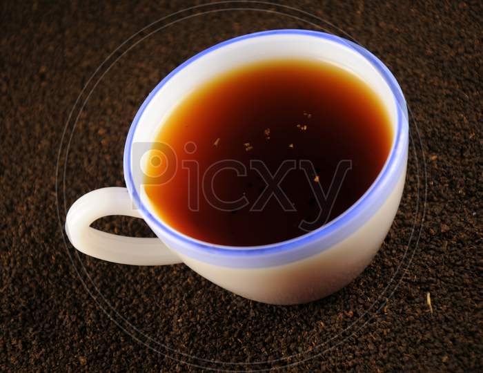 Cup Of Tea With And Black Tea Leaves