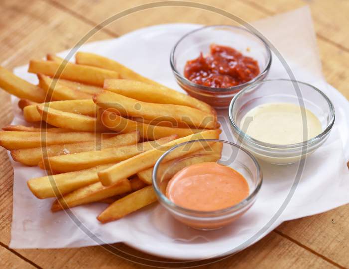 Tasty French Fries On Wooden Table Background