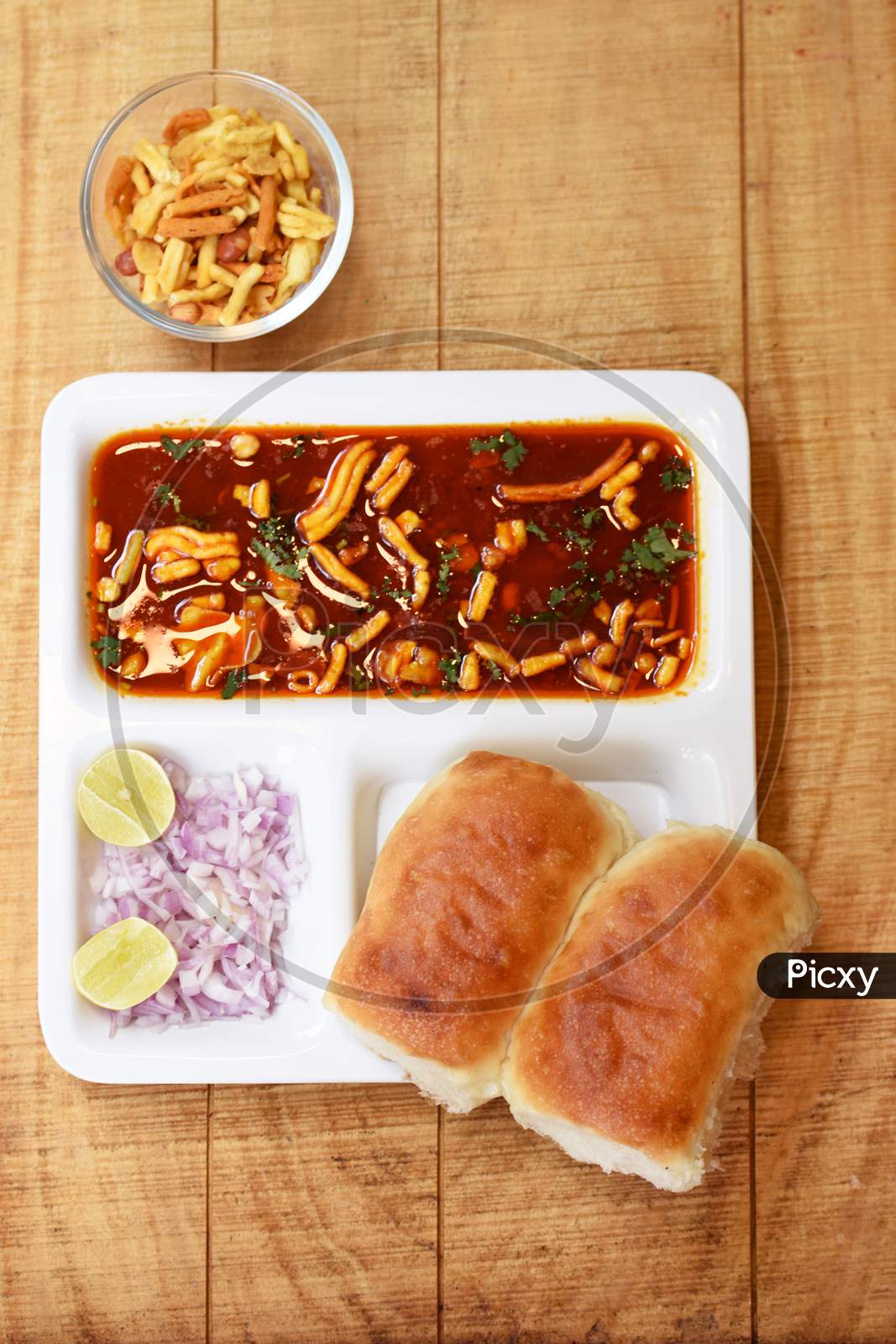 Indian Delicious "Misal Pav" With Onion And Coriander Spread On Top Of Curry Wheat Bread