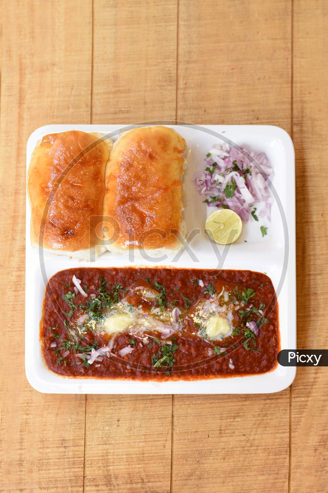 Indian Delicious Pav Bhaji With Onion And Coriander Spread On Top Of Curry Wheat Bread Pav Bhaji Fast Food Dish From India.