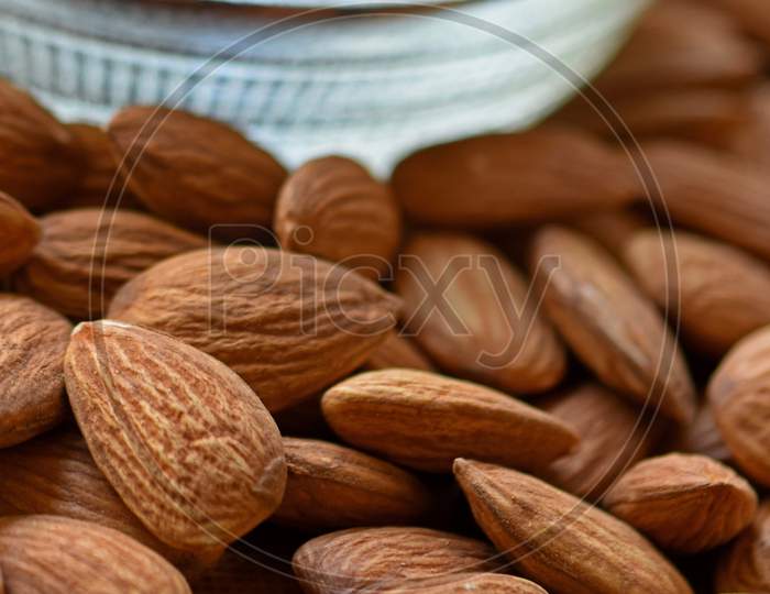 Almonds In Bowl, Group Of Almond Nuts Isolated On White Background. Depth Of Field