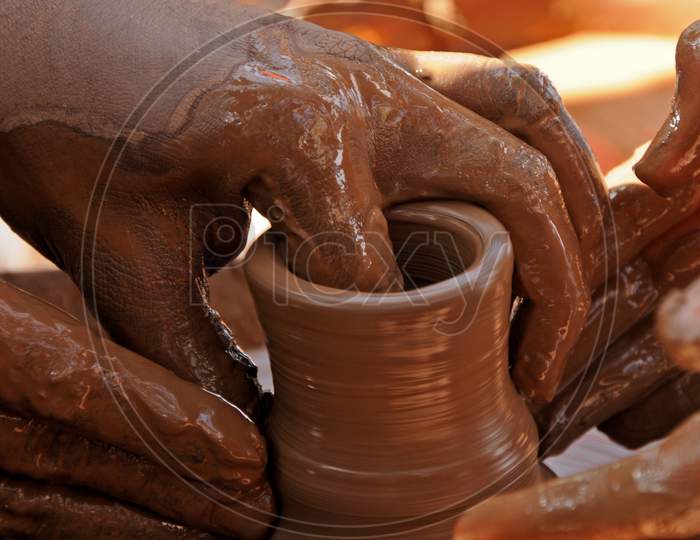 Teacher And Kid Making Ceramic Pot On Pottery Wheel