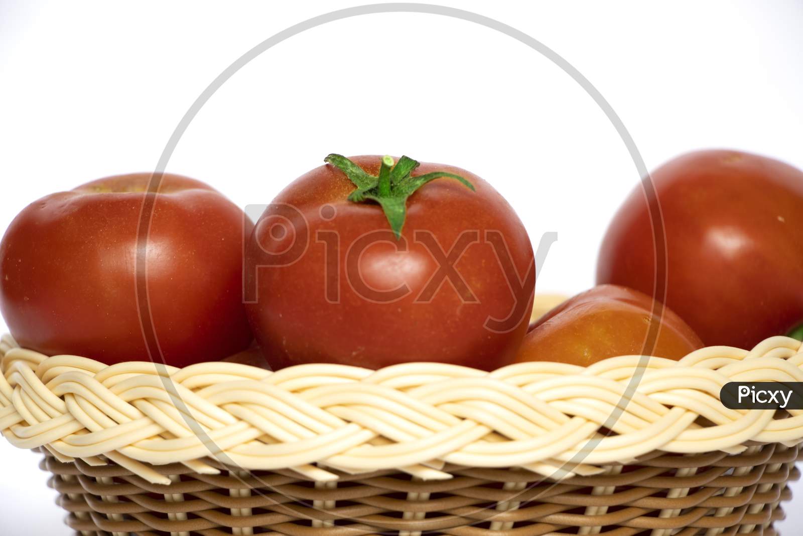 Red Tomato In Wooden Basket