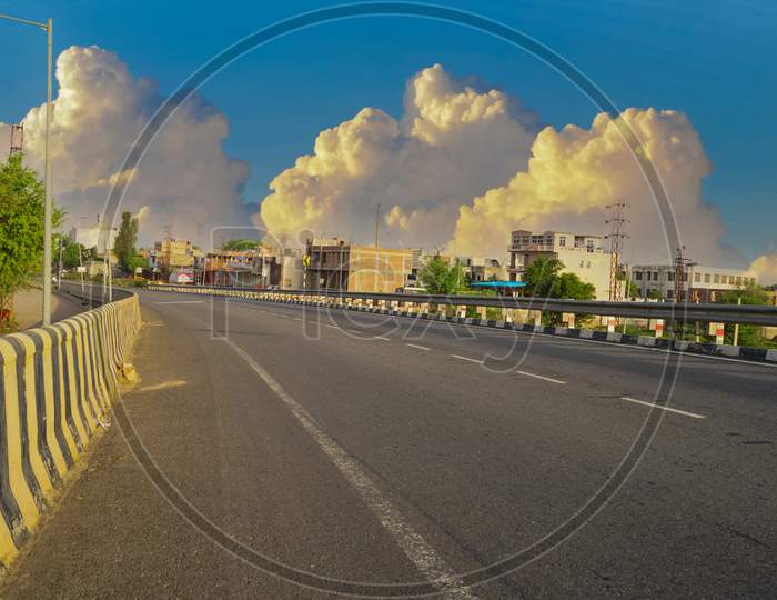 Asphalt Road And City Skyline With Buildings In Jaipur, India. Cloudy Sky And Highway Landscape.