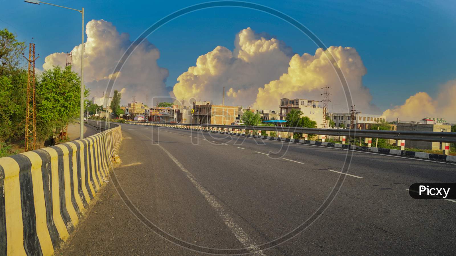 Asphalt Road And City Skyline With Buildings In Jaipur, India. Cloudy Sky And Highway Landscape.