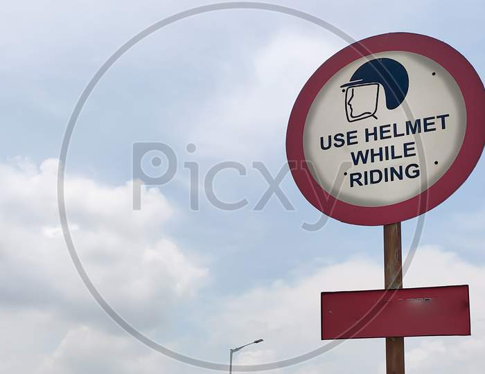 Traffic Rules And Signs Board On Road For Use Helmet While Riding For The Driver As Warning.