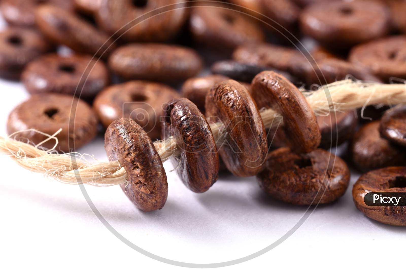 Wooden Beads With Natural Jute String Twine Rope On White Background. Close Up, Macro.