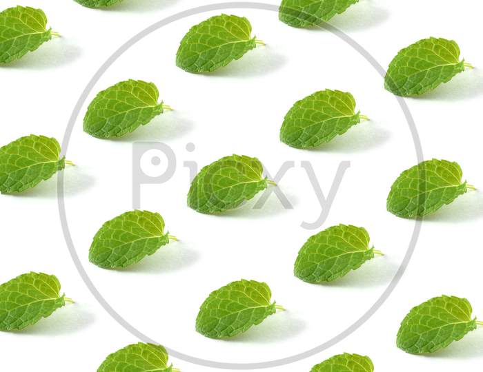 Minimal Composition Pattern Background Of Green Mint Leaves On White Isolated Background. Pattern Made Of Mint Leaf.