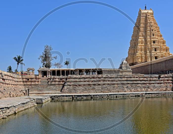 Virupaksha Temple View  From  Backside With Pond, Located In The Ruins Of Ancient City Vijayanagar At Hampi, India.