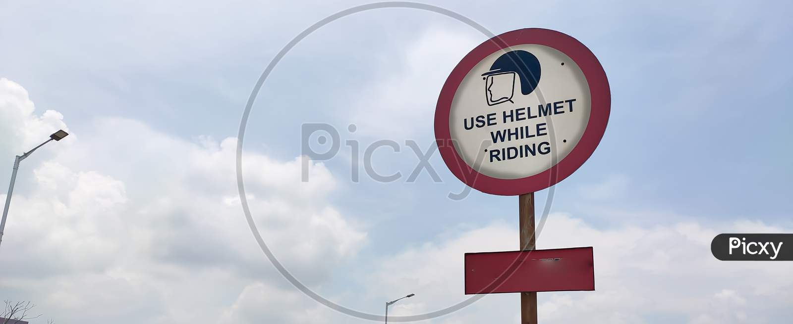 Traffic Rules And Signs Board On Road For Use Helmet While Riding For The Driver As Warning.