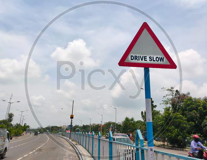 Traffic Rules And Signs Board On Road For Drive Slow For The Driver As Warning.