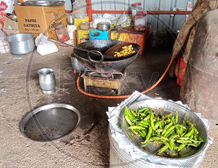 Indian highway road side village restaurant fresh fried kanda bhajji with fried chillies
