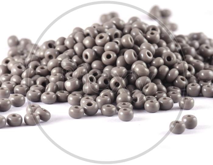 Close Up Of Gray Beads On The White Background. Background Or Texture Of Beads. Macro,It Is Used In Finishing Fashion Clothes. Make Bead Necklace Or String Of Beads For Woman Of Fashion.