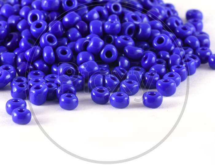 Close Up Of Blue Beads On The White Background. Background Or Texture Of Beads. Macro,It Is Used In Finishing Fashion Clothes. Make Bead Necklace Or String Of Beads For Woman Of Fashion.