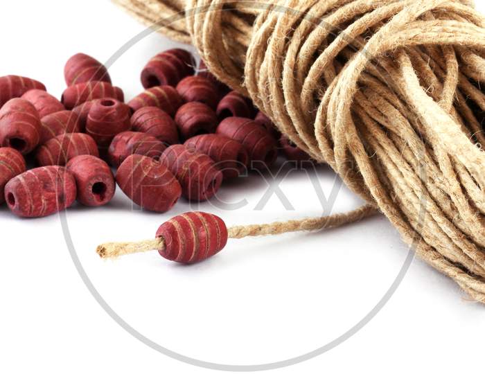 Wooden Beads With Natural Jute String Twine Rope On White Background. Close Up, Macro.