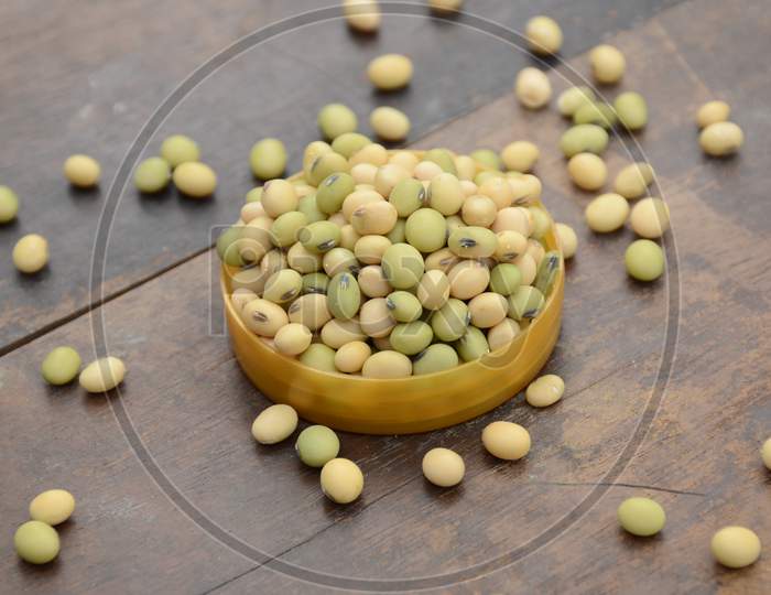 Closeup Bunch The Ripe Green Yellow Soybean In The Plastic Bowl Over Out Of Focus Wooden Brown Background.