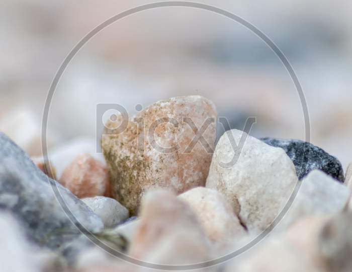 Raw rocks and minerals as natural stones background with crushed and rough material at a nice coast or rocky beach show nuggets and sandstones