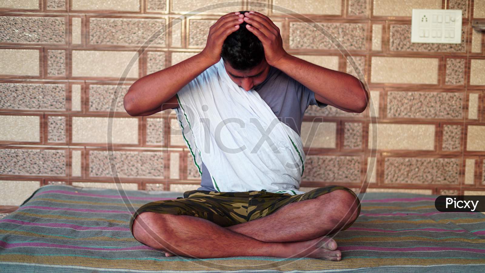 Young Asian Man Sitting In Yoga Position And Meditating At Home. Worldwide Yoga Day Concept.