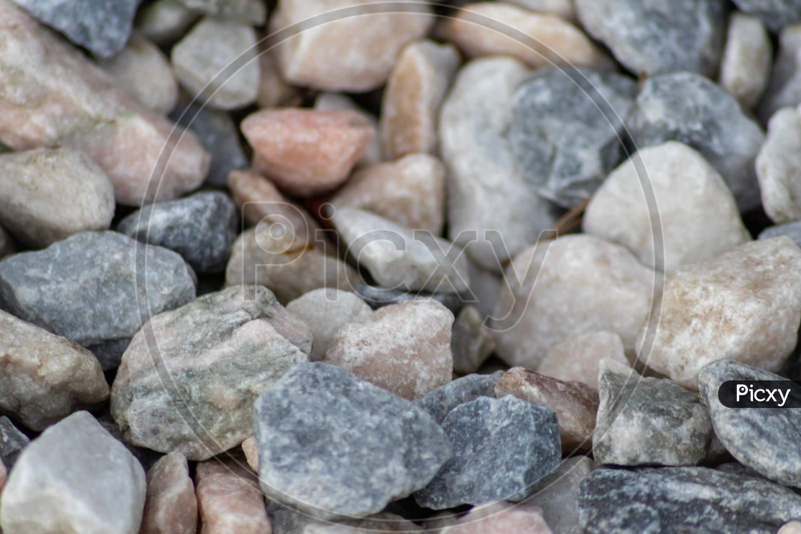 Raw rocks and minerals as natural stones background with crushed and rough material at a nice coast or rocky beach show nuggets and sandstones