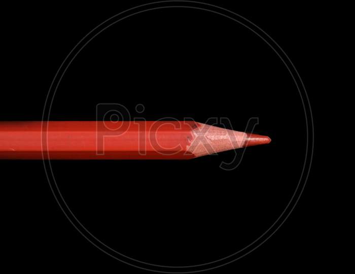 Red pencil isolated on black background