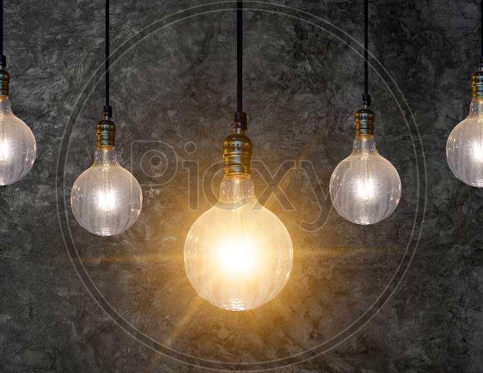Different Light Bulb Idea Many Bulbs Are Arranged In A Row And One Of Them Is Illuminated. Concept Idea