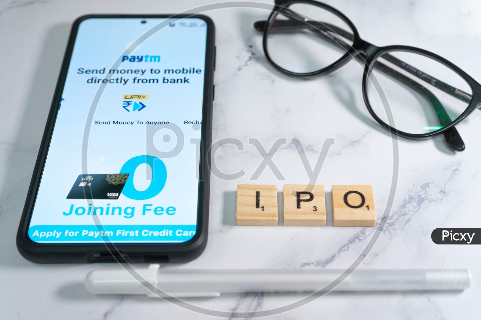 Paytm Logo Screen On Mobile Phone With Pen And Spectacles Placed Nearby Showing The Ipo Of The Indian Startup Unicorn Decacorn Payment Services Provider For Cashless Payment
