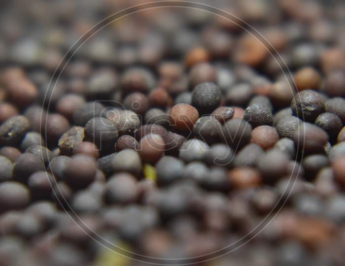 A Close Up Picture Of Mustard Seeds In Black