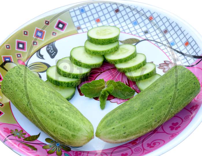 Closeup Sliced Green Ripe Cucumber With Mint In The Plate Isolated On White Background.