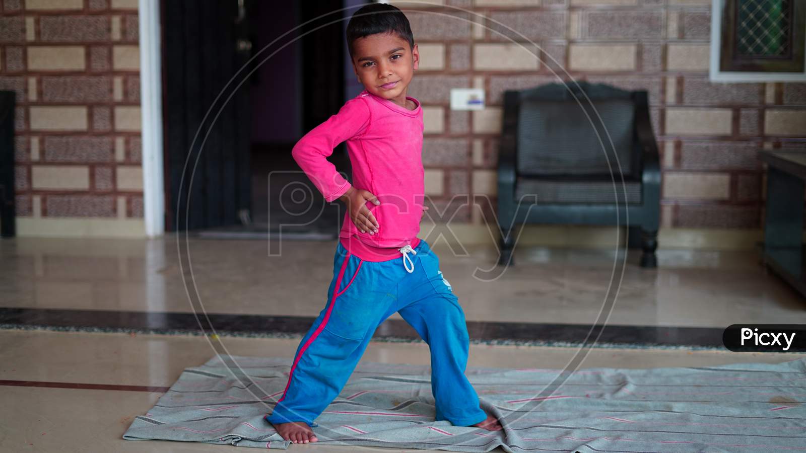 Indian Cute Little Boy Exercising At Home. Family Working Out At Home. Worldwide Yoga Day Concept.