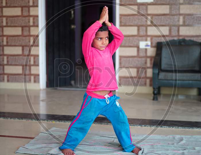 Indian Cute Little Boy Exercising At Home. Family Working Out At Home. Worldwide Yoga Day Concept.