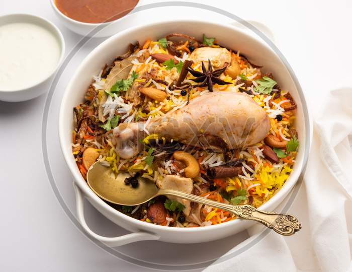 Restaurant Style Spicy Chicken Biryani Served With Raita And Salan, Popular Indian Or Pakistani Non Vegetarian Food