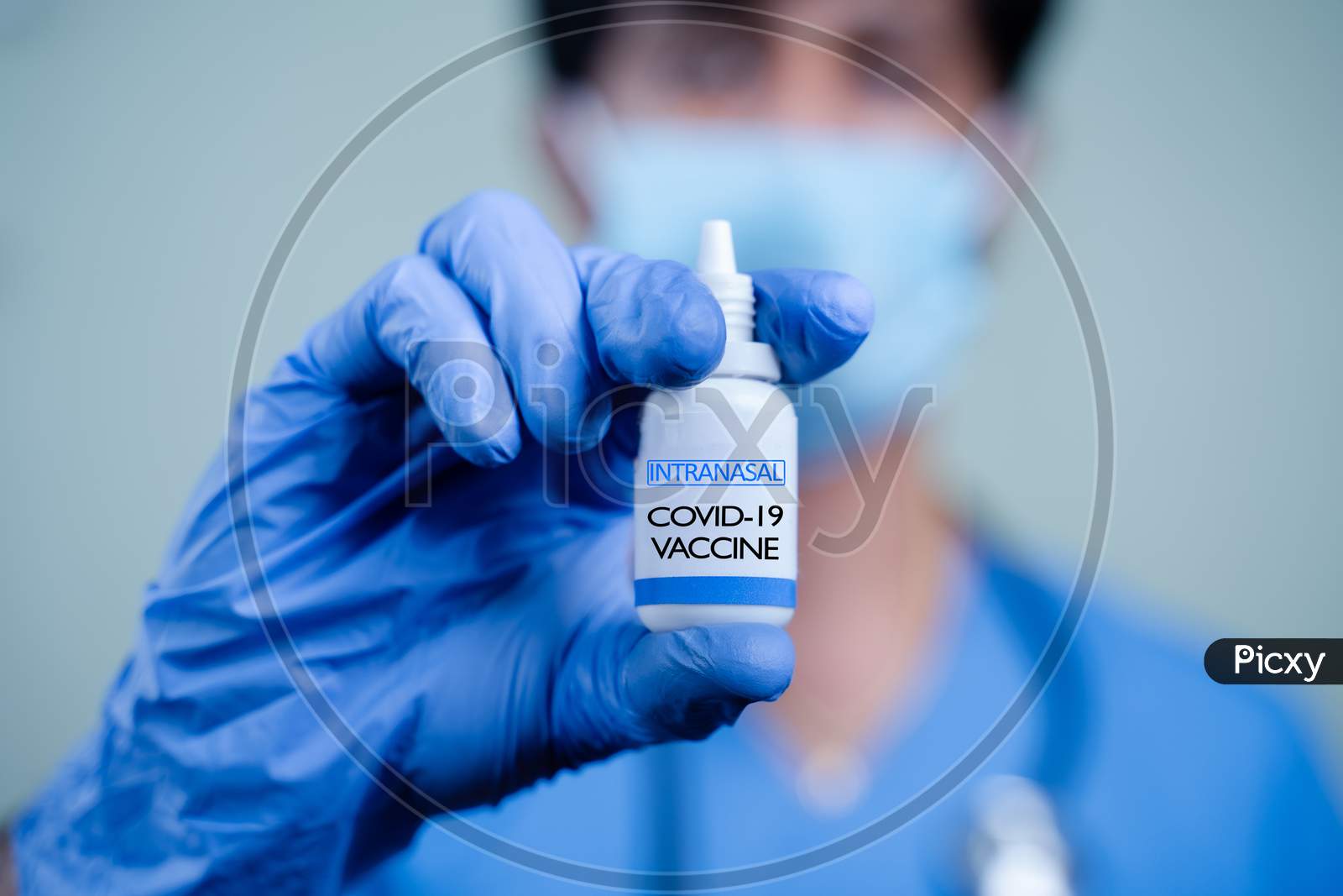 Close Up Hands Of Doctor Or Nurse Holding Intranasal Vaccine Spary Bottle For Coronavirus Or Covid-19 Pandemic