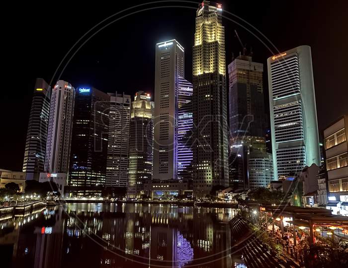 illuminating Buildings and Skyscrapers on the side of ' Marina Bay sands in Singapore (2020)  at night