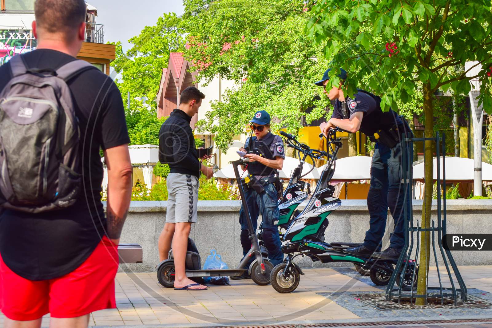 Palanga, Lithuania, 10Th June, 2021: Female Police Officer Gives Penalty To Civilian On Scooter In Public I Palanga Resort, Lithuania