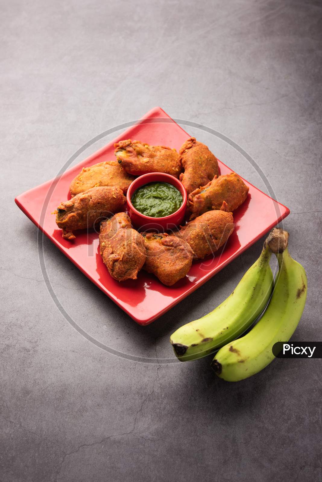 Image of Banana Fritter Or Pakora Or Raw Kela Pakoda Or Bajji Served ...