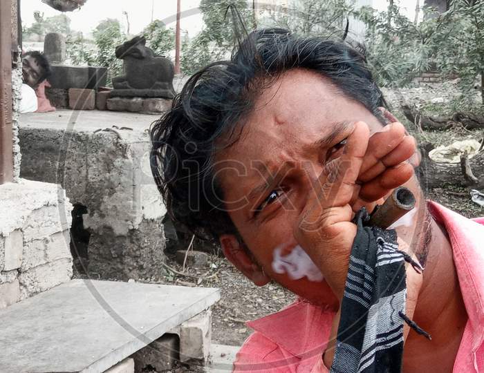 Indian labour smoking chillum