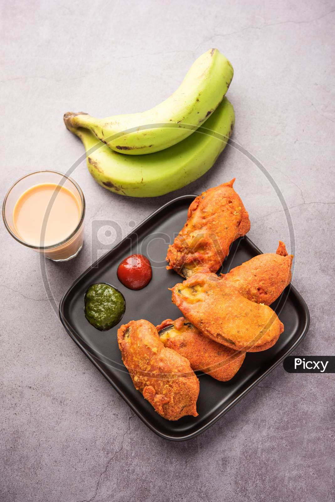 Image of Banana Fritter Or Pakora Or Raw Kela Pakoda Or Bajji Served ...