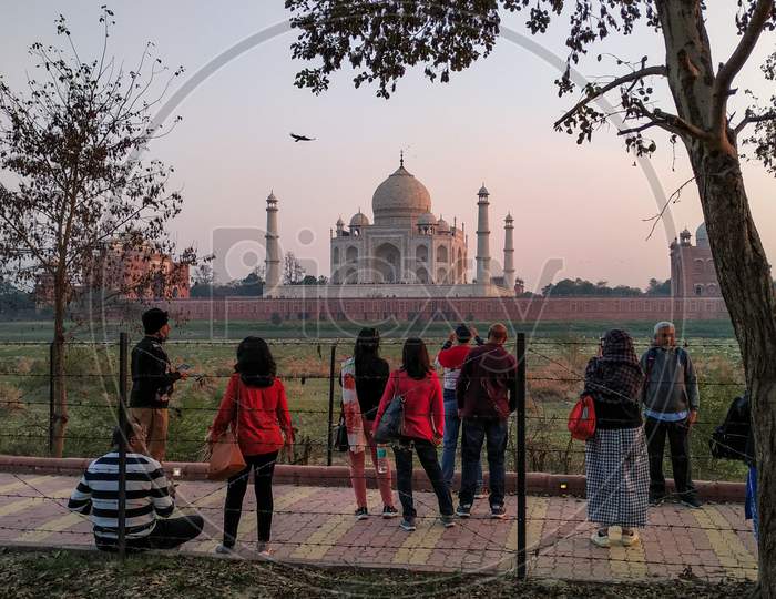 Foreigners enjoying Taj Mahal from Mehtaab Bhag