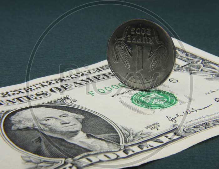 Indian Rupee Coin And American Dollar Note