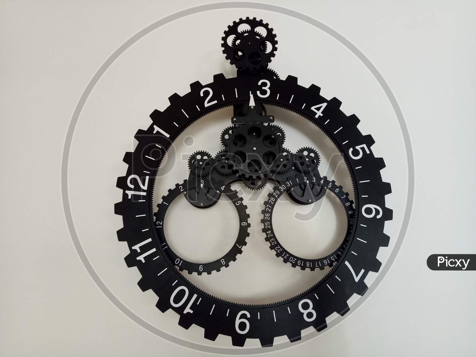 BLACK & WHITE WALL CLOCK HANGING WITH WHITE BACKGROUND