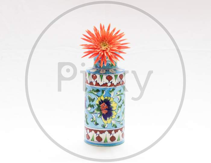 beautiful blue flower vase having floral pattern with bright orange flower