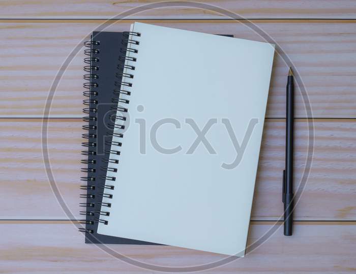 Note Book With Pen On Wooden Table. Flat Lay, Top View