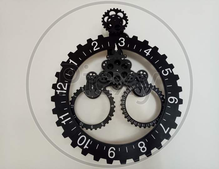 BLACK & WHITE WALL CLOCK HANGING WITH WHITE BACKGROUND