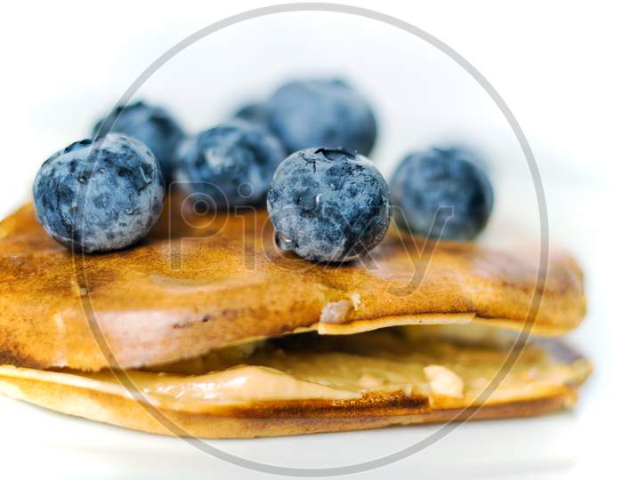 Healthy Food Concept Displaying Macro Close Up Shot Of Pan Cake With Blueberries Fruit And Banana Isolated On White Background
