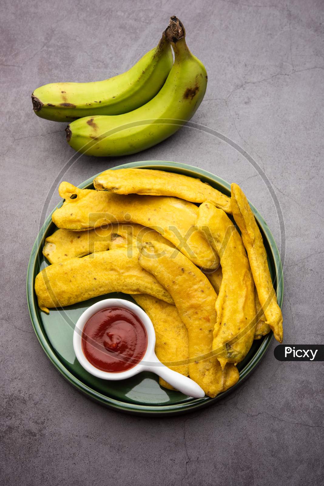 Image of Banana Fritter Or Pakora Or Raw Kela Pakoda Or Bajji Served