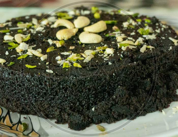 Biscuit cake with dry fruit filling decorated with cashew pistachios